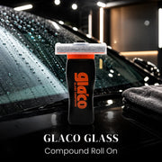 Glaco Glass Compound Roll On bottle placed on wet car windshield with rain drops
