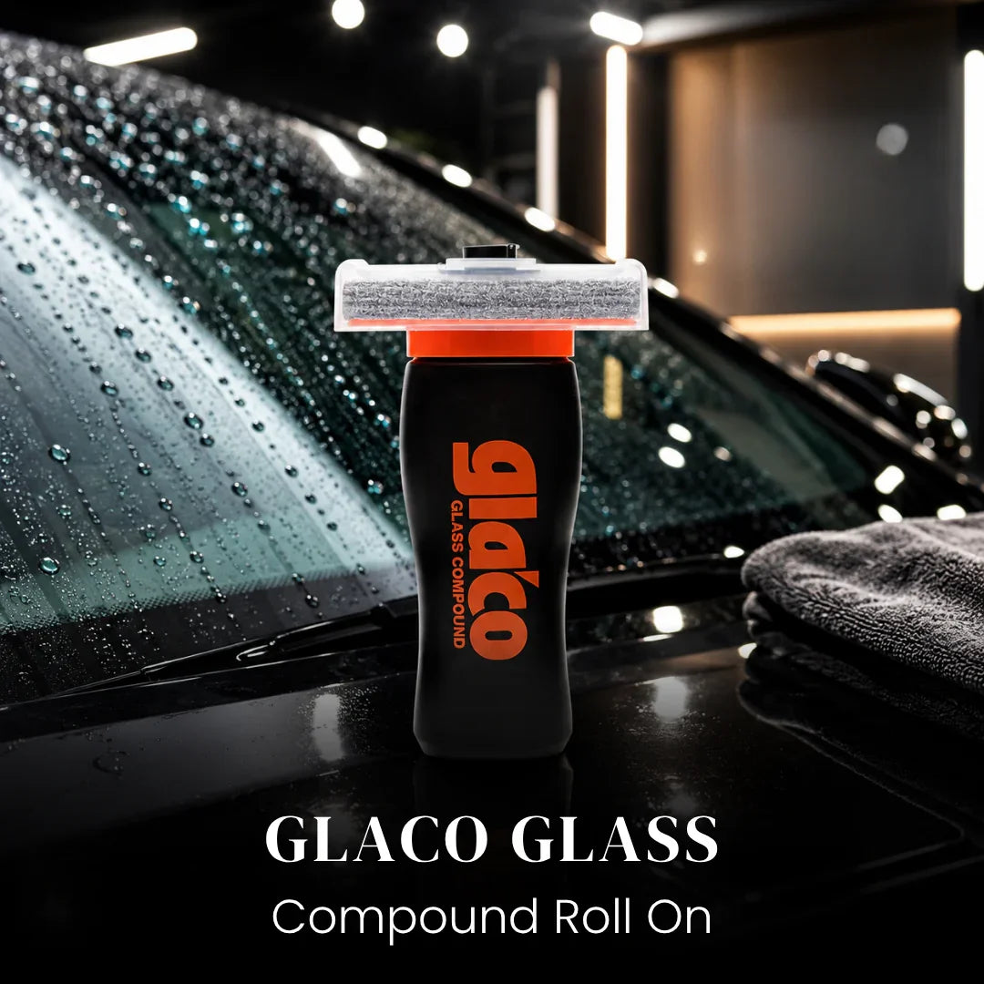 Glaco Glass Compound Roll On bottle placed on wet car windshield with rain drops
