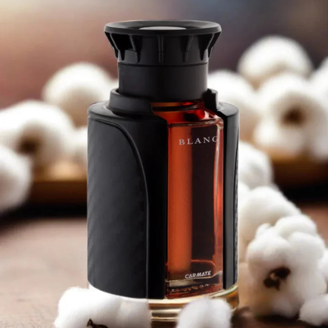 Carmate Blanc car perfume with black holder, amber liquid, surrounded by cotton for fresh auto scent