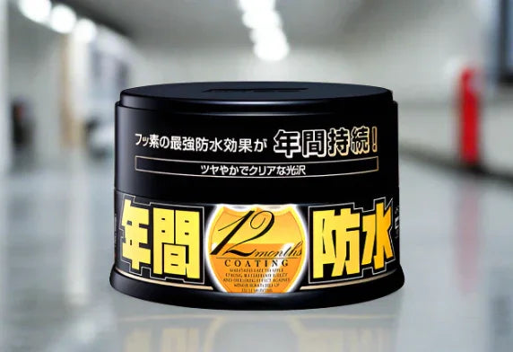 Soft99 Fusso Coat 12 Months Wax tin for dark cars on reflective floor
