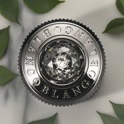 Luxury car perfume diffuser with crystal center and BLANGOB logo, surrounded by green leaves